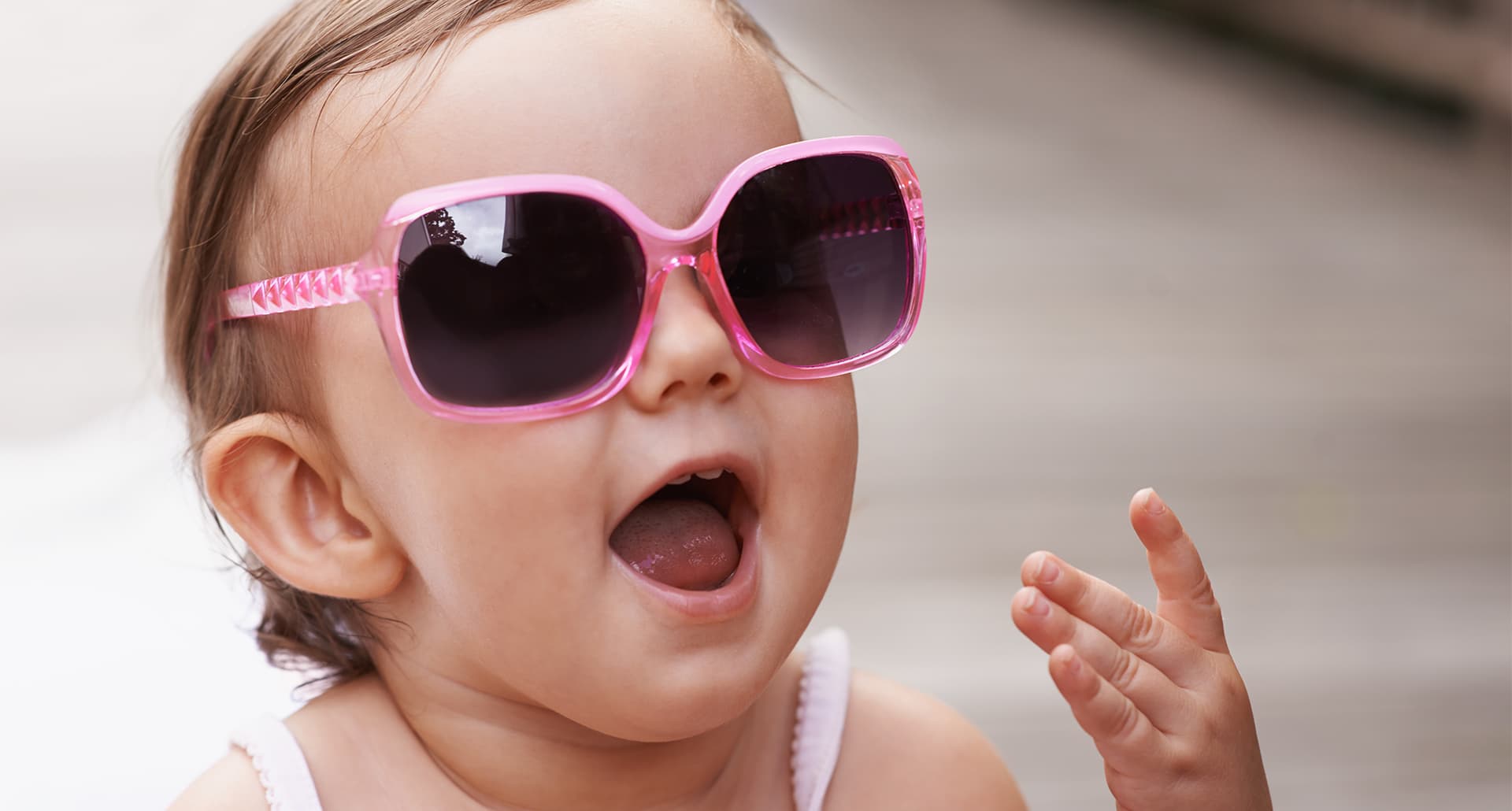new york inspired baby names: baby wears pink oversized sunglasses
