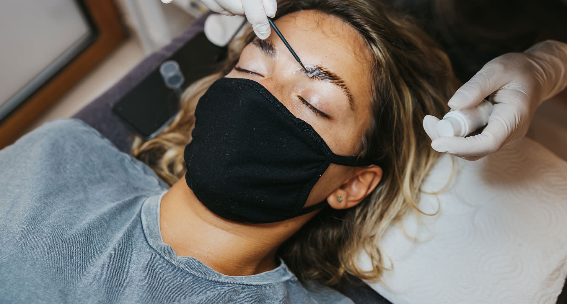 a photo of a woman getting brow lamination