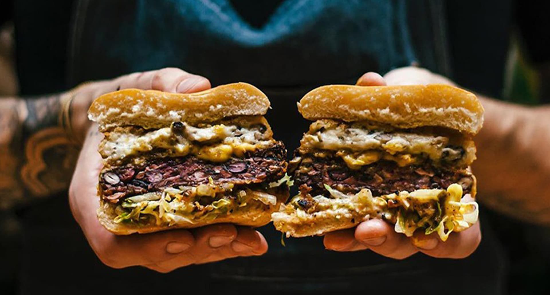 hands holding a vegan burger