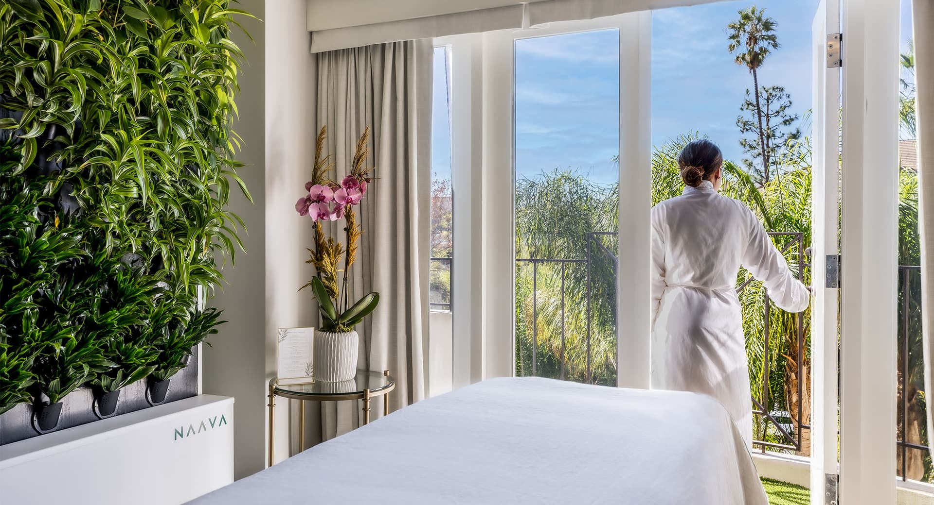 Best Spas in Los Angeles Universal. woman in robe looking out on the balcony of the spa.