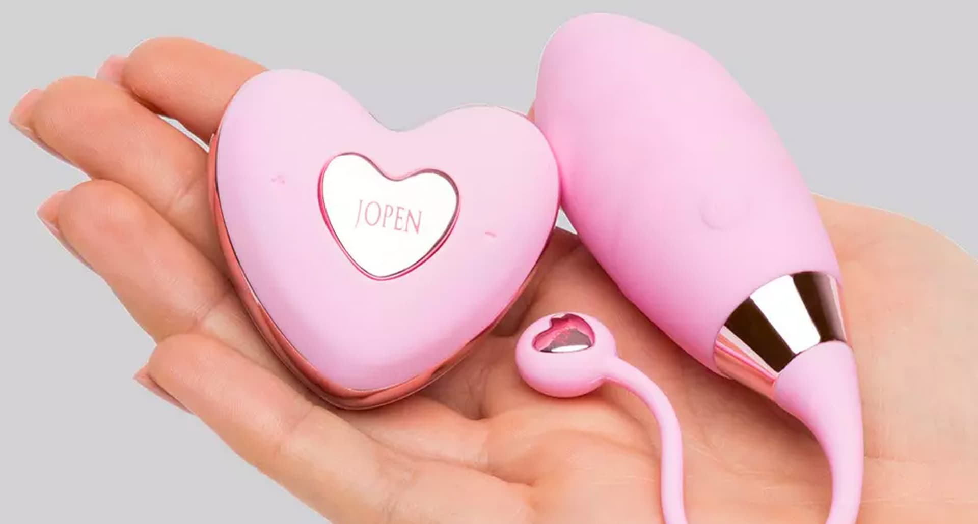 Vibrating Eggs: light pink Amour Rechargeable Remote Control Egg Vibrator in a woman’s hand