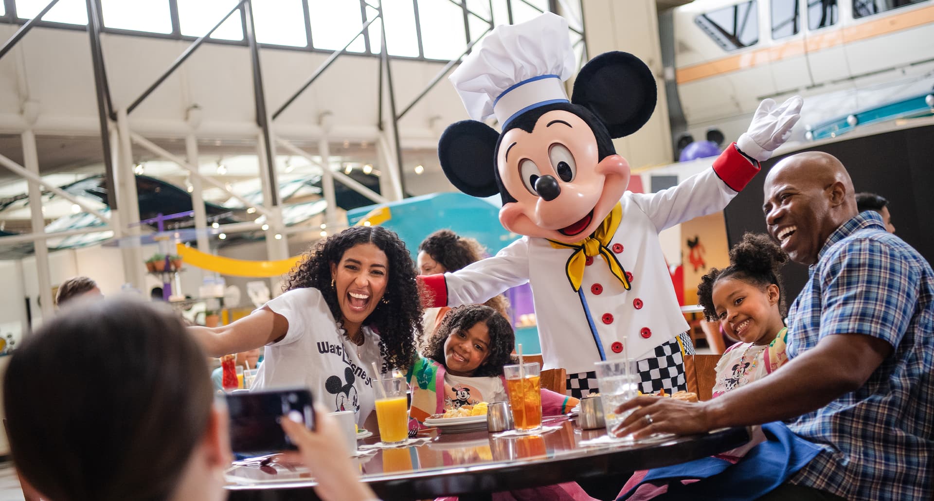 Best Disney character dining: Mickey poses with a family at the Disney Contemporary Resort