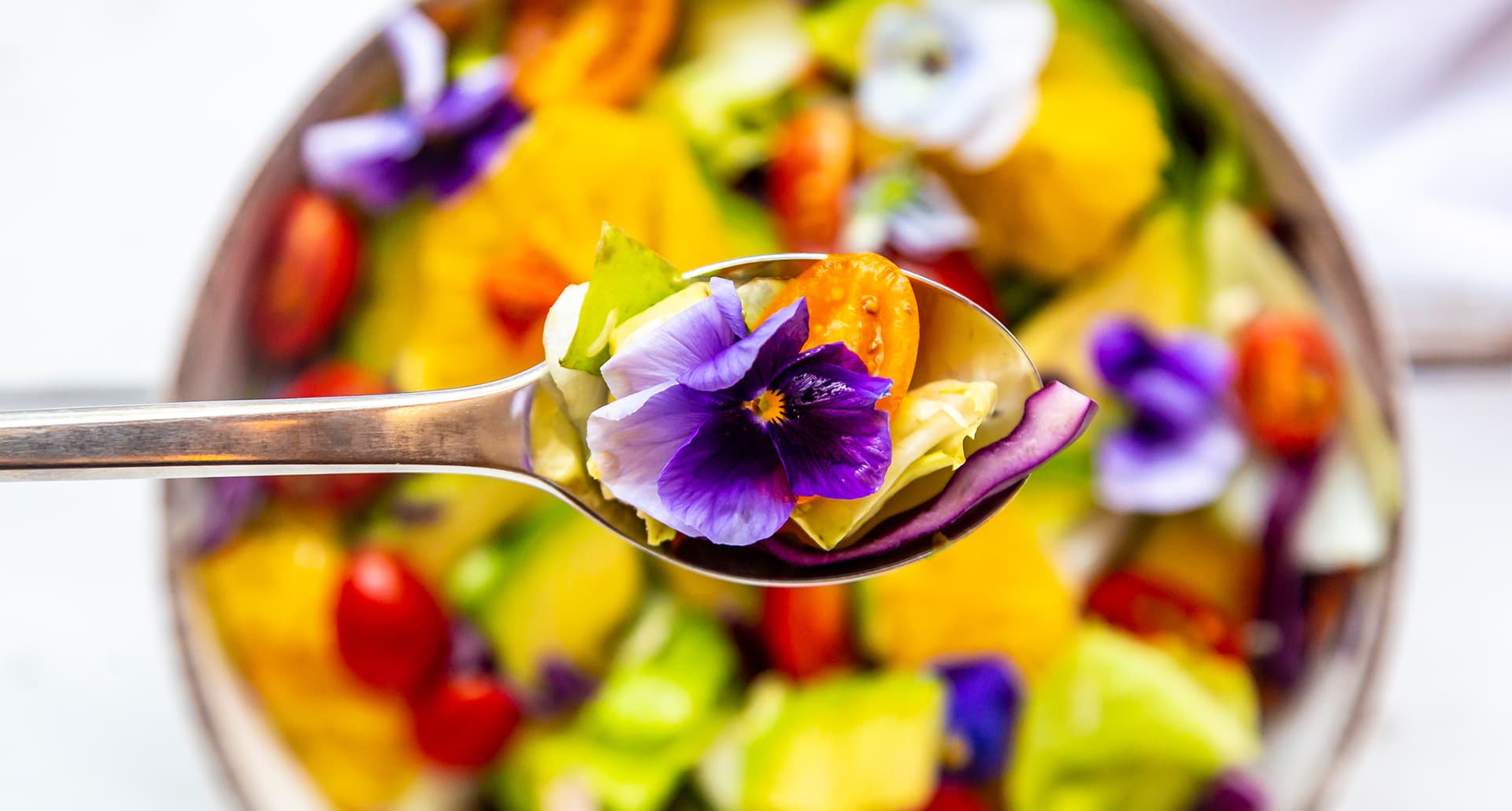 edible flowers: a bowl of flowers.