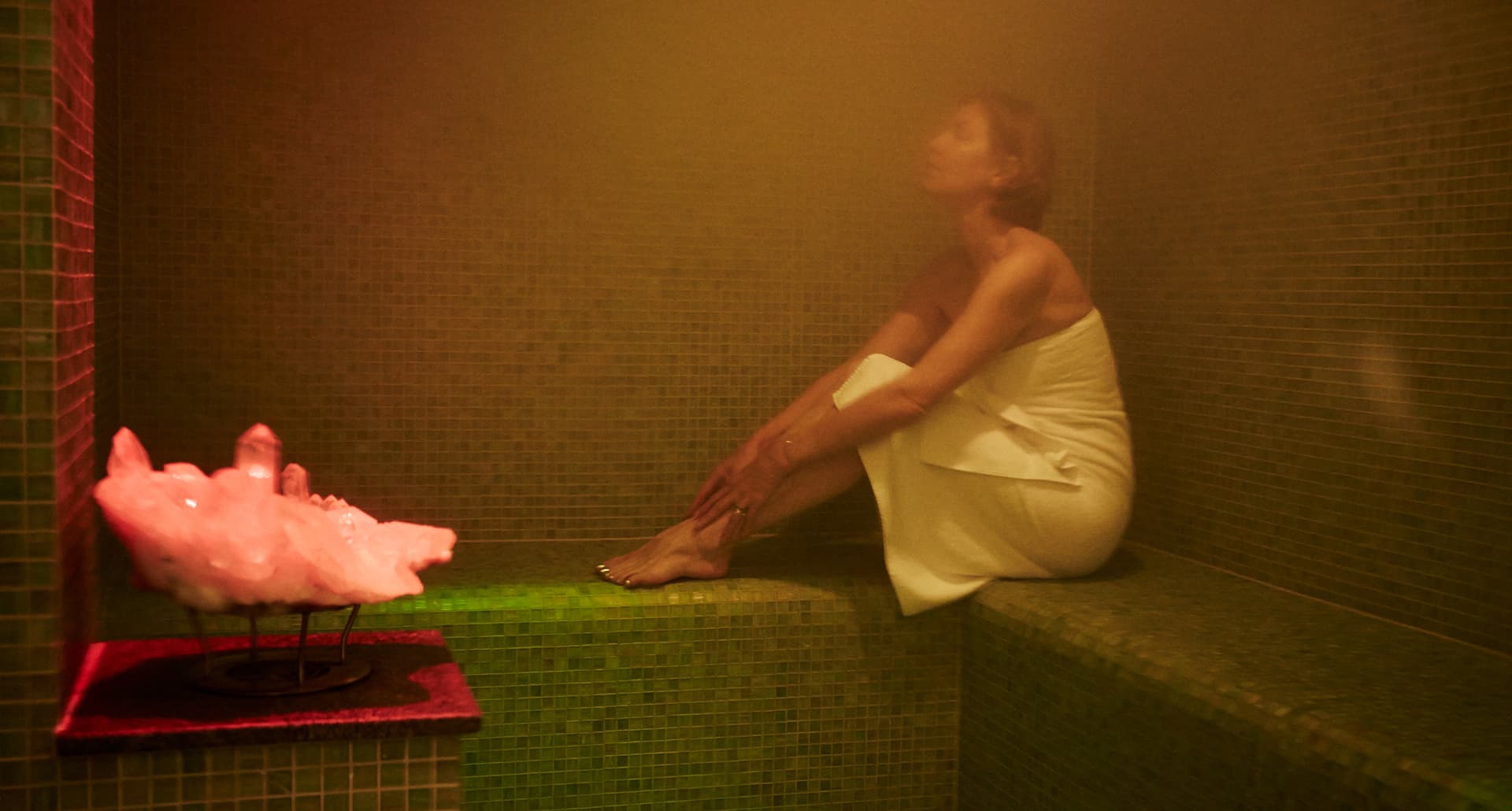 steam room benefits: woman sits alone in steam room