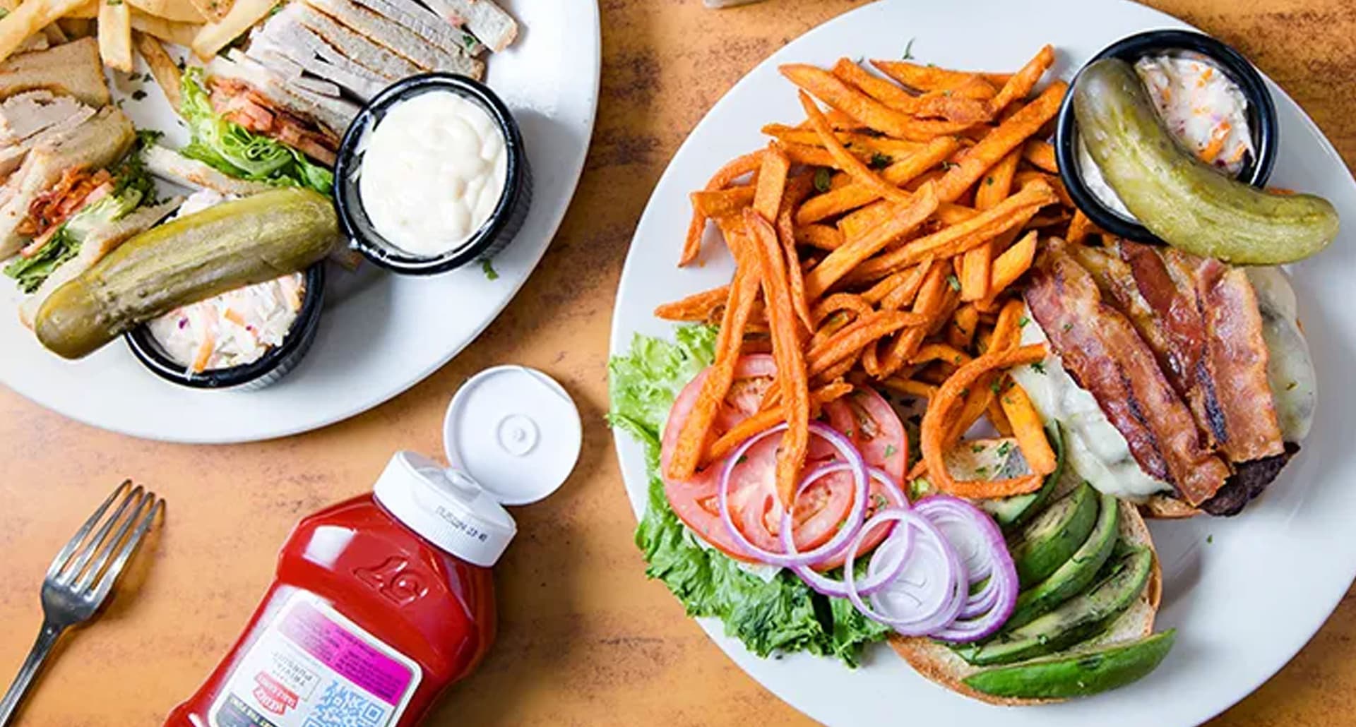 Best-24-Hour-Restaurants-in-NYC: Multiple plates full of diner food on a table.