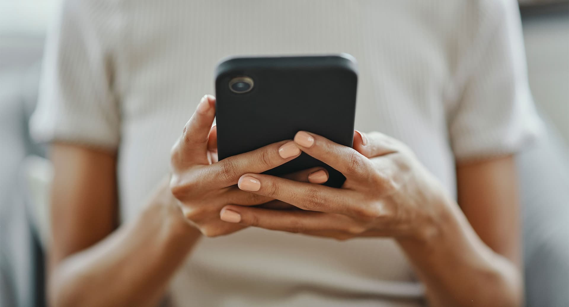 close up of a woman texting on her phone