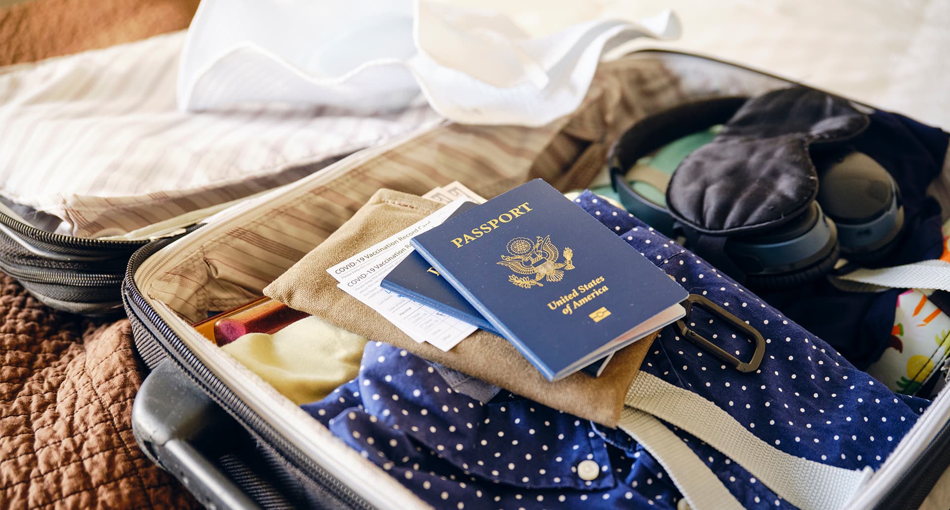 International Travel Packing List: lifestyle image of Suitcase and Passport