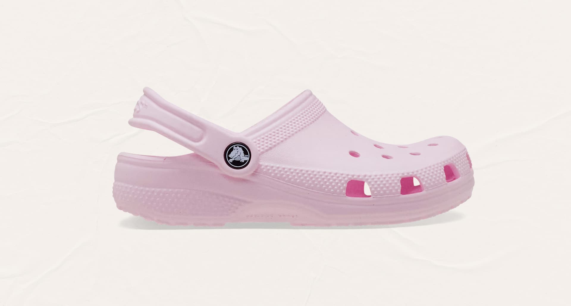 A light pink Croc on a plain background for a story on what podiatrists really think of Crocs
