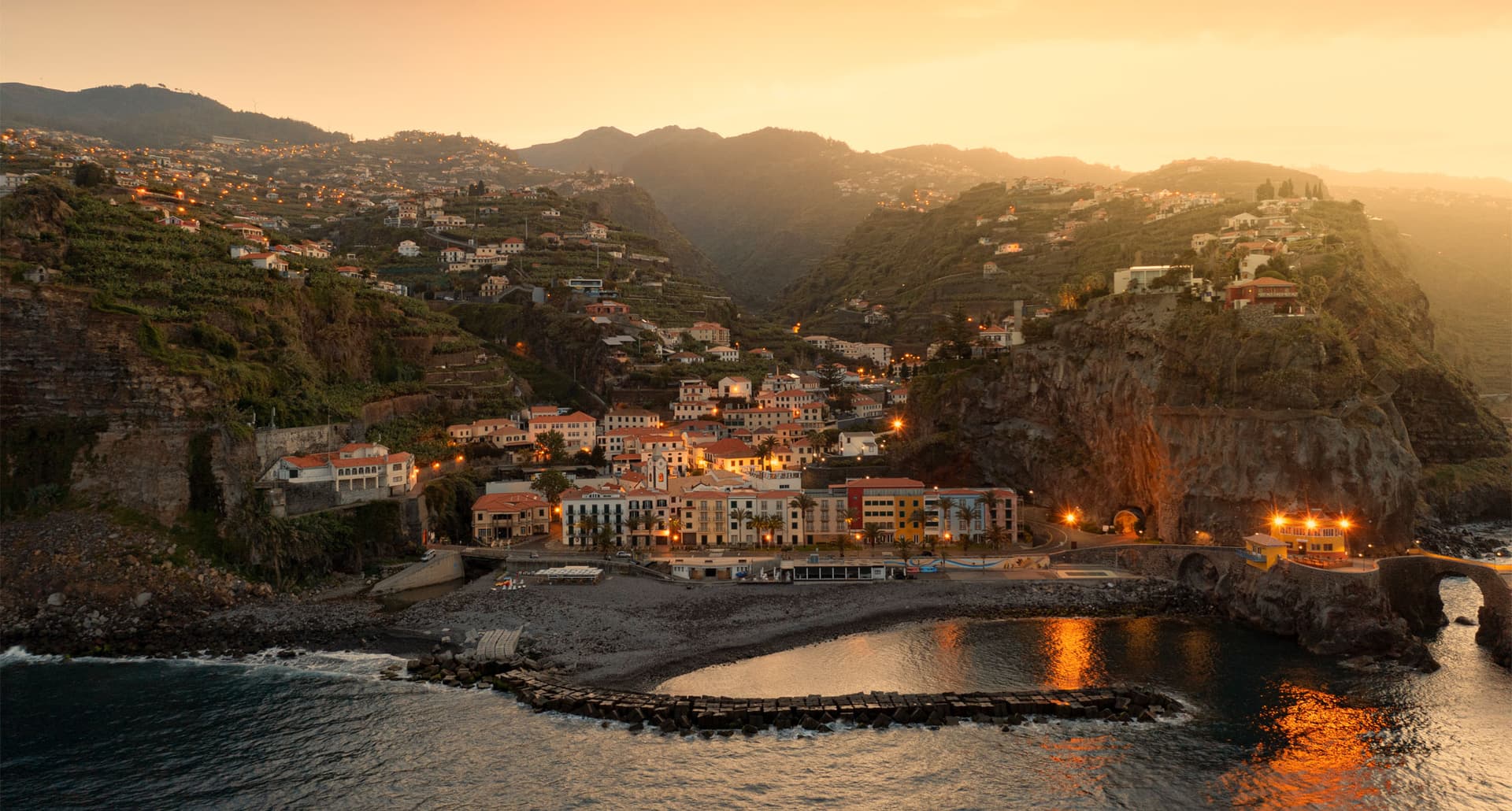 Best Places to Travel in October - Aerial view of Ponta do Sol seaside town at sunset, Atlantic Ocean, Madeira island, Portugal