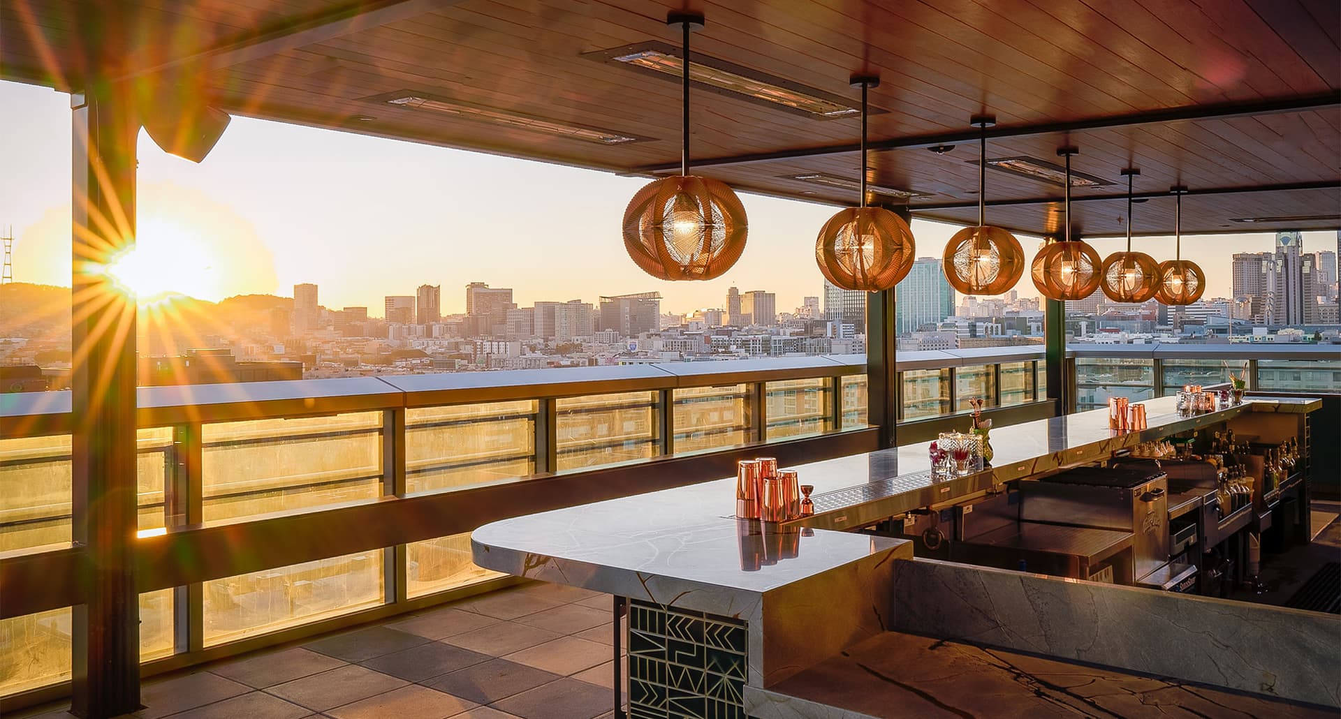 Best Rooftop Bars in San Francisco - A photo from the bar area Kaiyo. It overlooks the water at sunset.