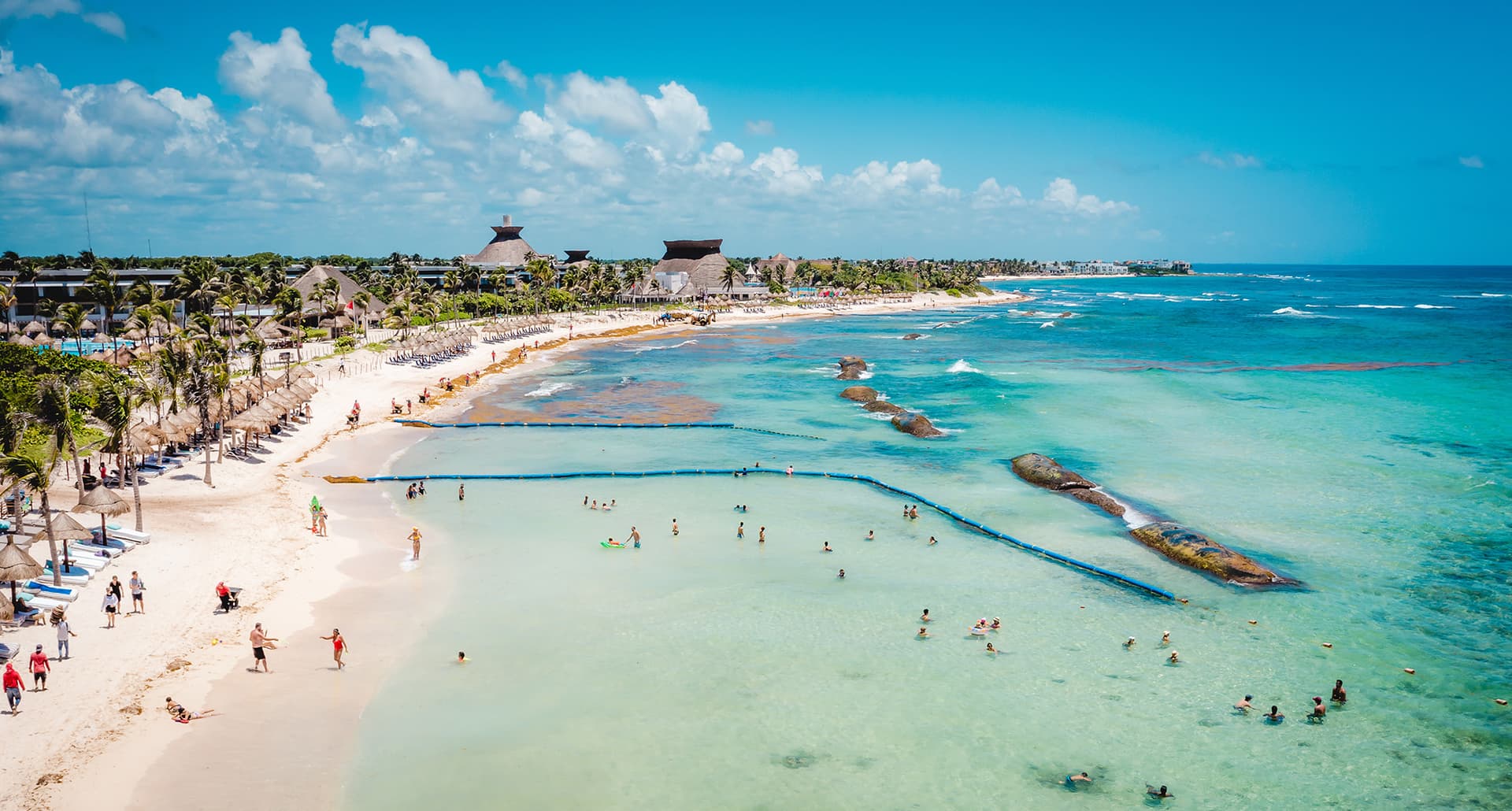 Tulum-resorts: a shot of a large beach in Tulum with crystal blue water.