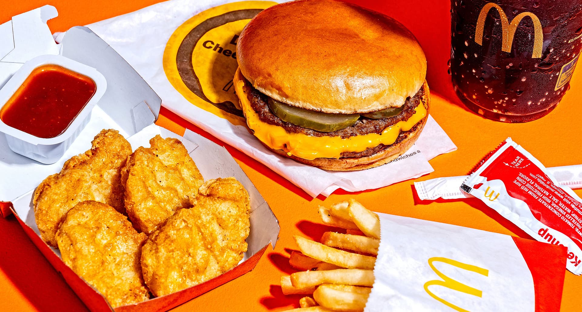 best high protein fast food meals: mcdonald's mcdouble, mcnuggets, fries and coke on a table