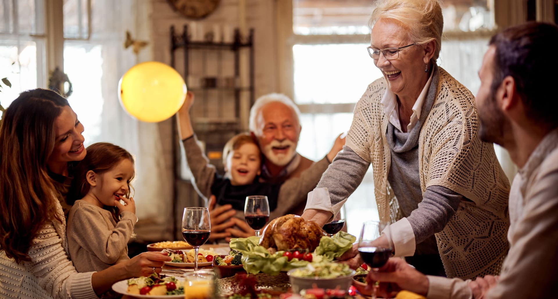 thanksgiving-day-activities: A family sitting around the dinner table at Thanksgiving.