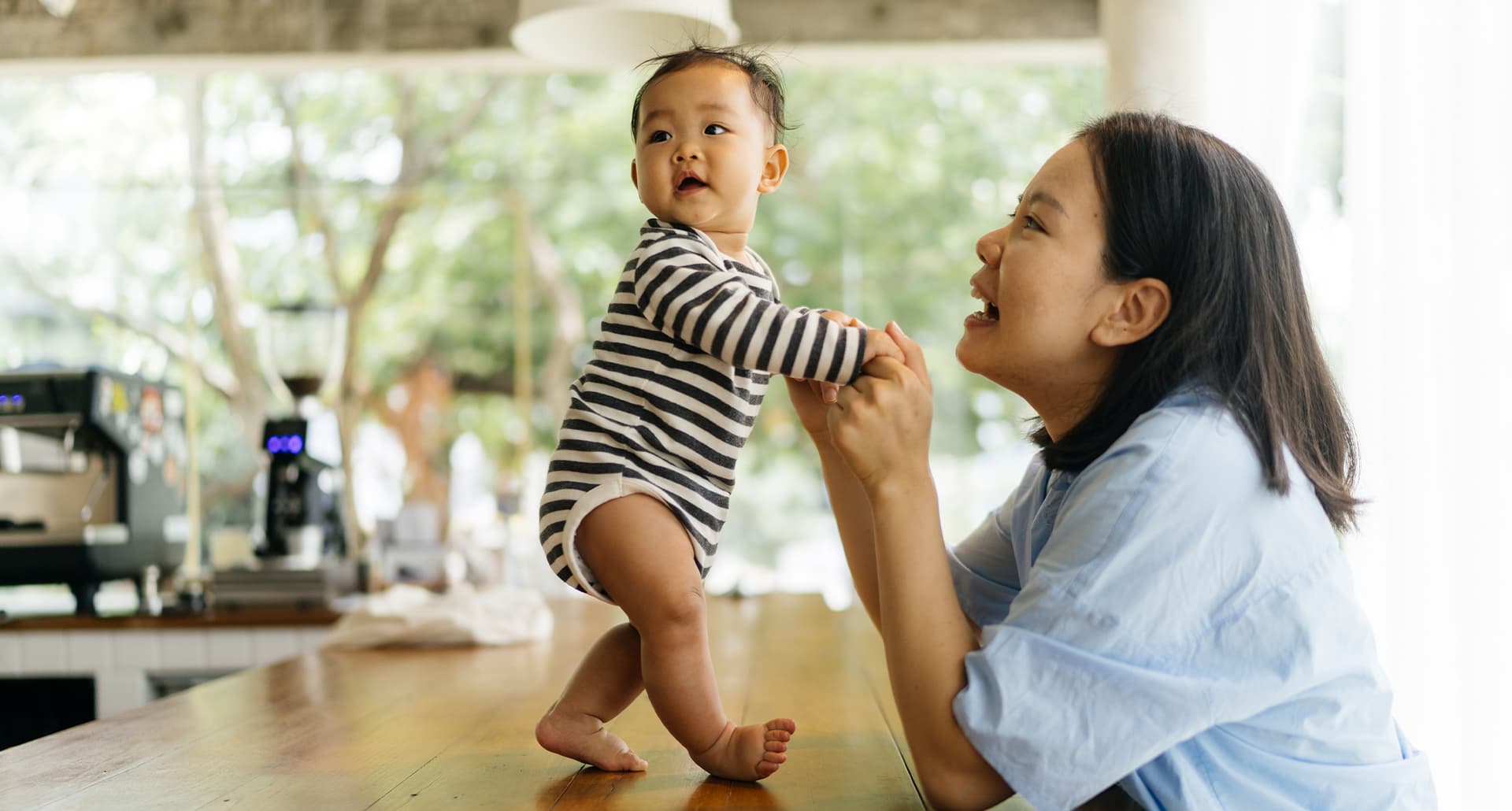 scientifically-proven-ways-to-raise-happy-kids: a mom holding her baby