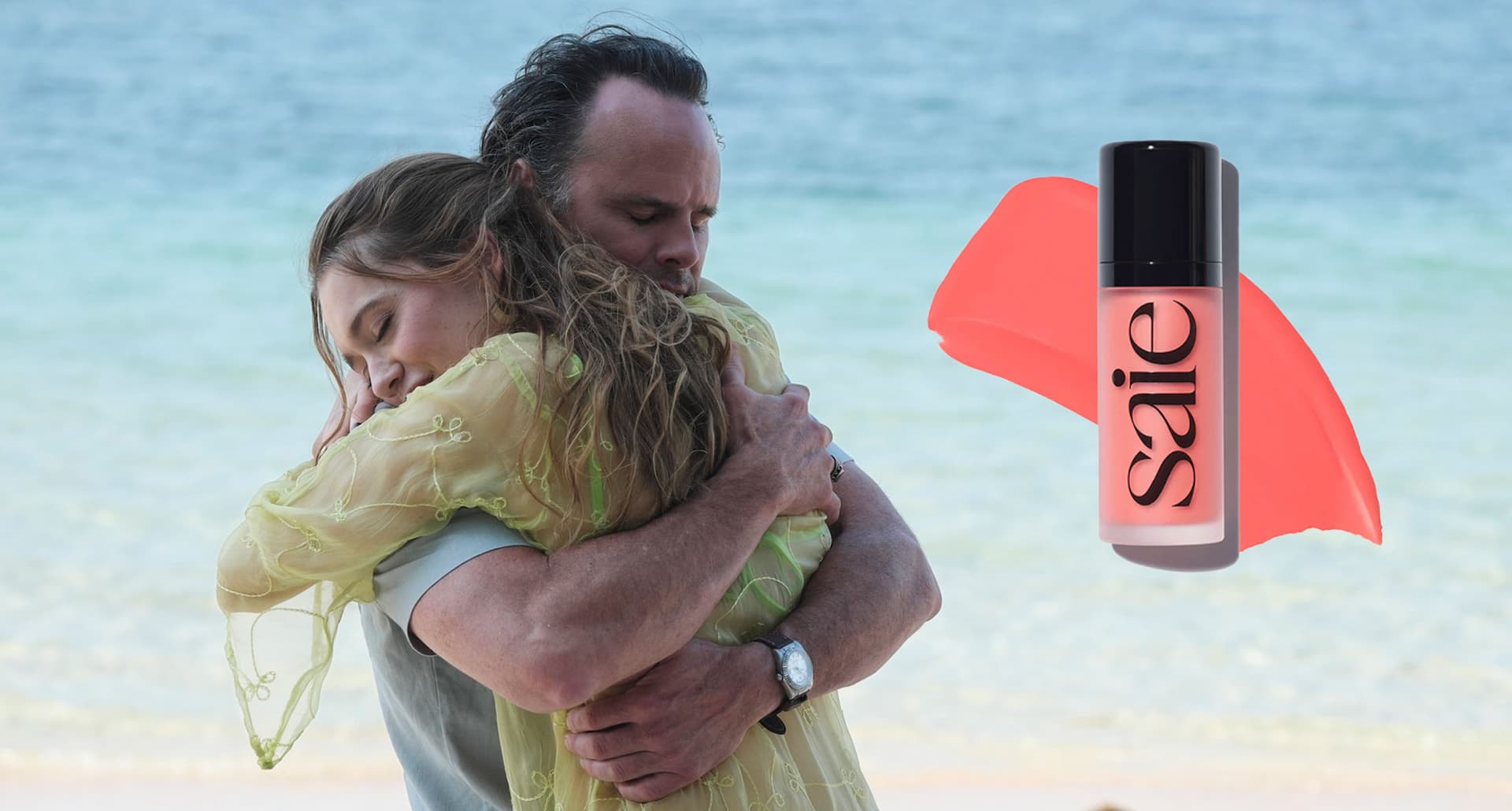 aimee-lou-wood-the-white-lotus-saie-blush: A photo of Aimee Lou Wood and Walter Goggins embracing on the set of 'The White Lotus.' There is a tube of Saie blush and a swatch next to them.